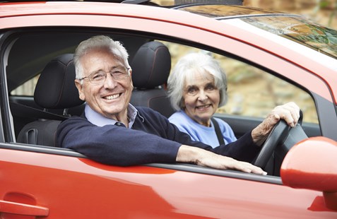 Over 70s couple in red car
