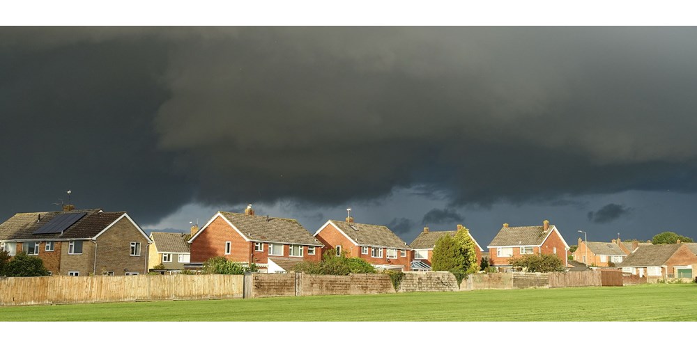 Landscape of houses with storm weather