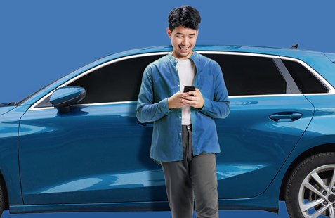Man leans against blue car