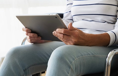 Women sitting in chair with tablet