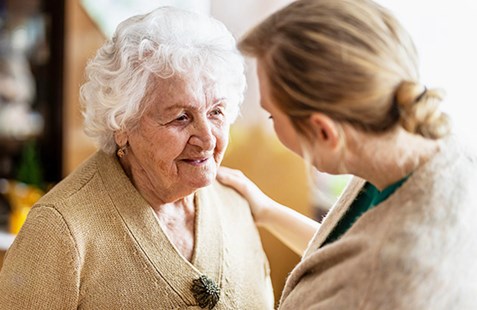 Elderly woman with carer
