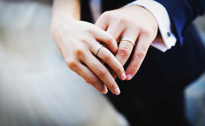 Close up of married couple's hands - with wedding rings