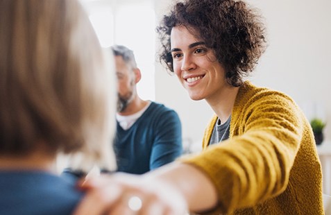 Women with hand on older woman's shoulder