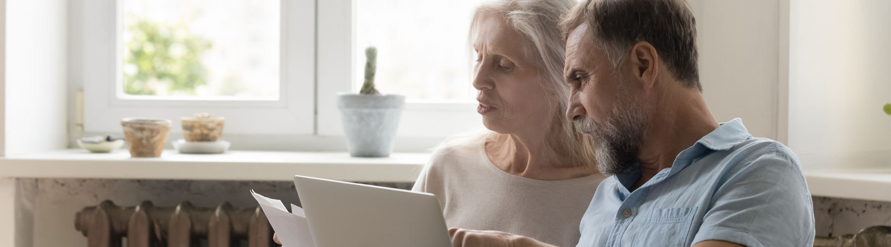 Couple using laptop at home