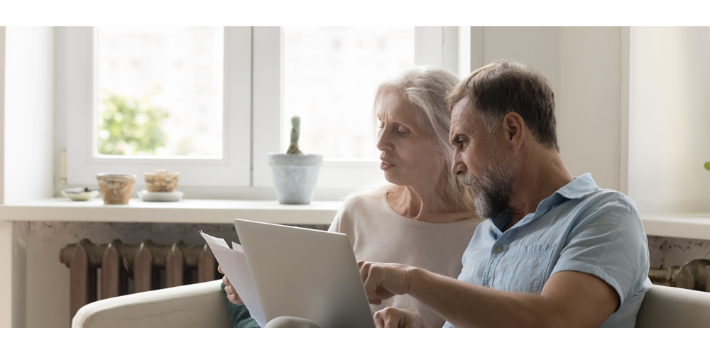 Couple using laptop at home