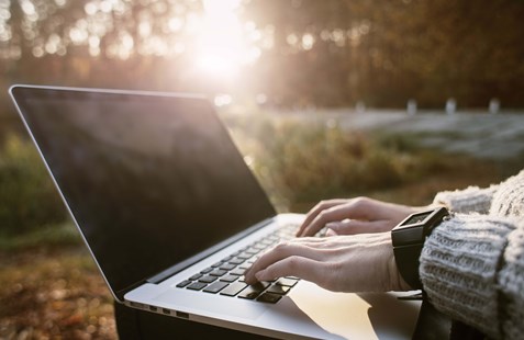Working on a laptop outside