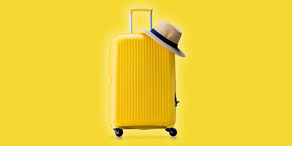Yellow suitcase and a hat