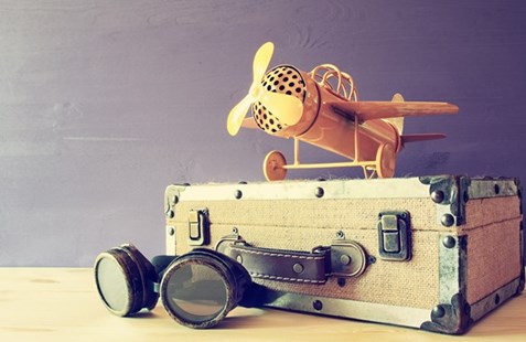Retro suitcase with toy plane and goggles