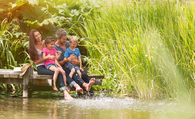 A family sat by a lake