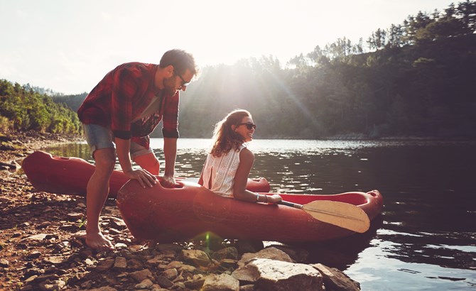 A man and a woman in a red canoe