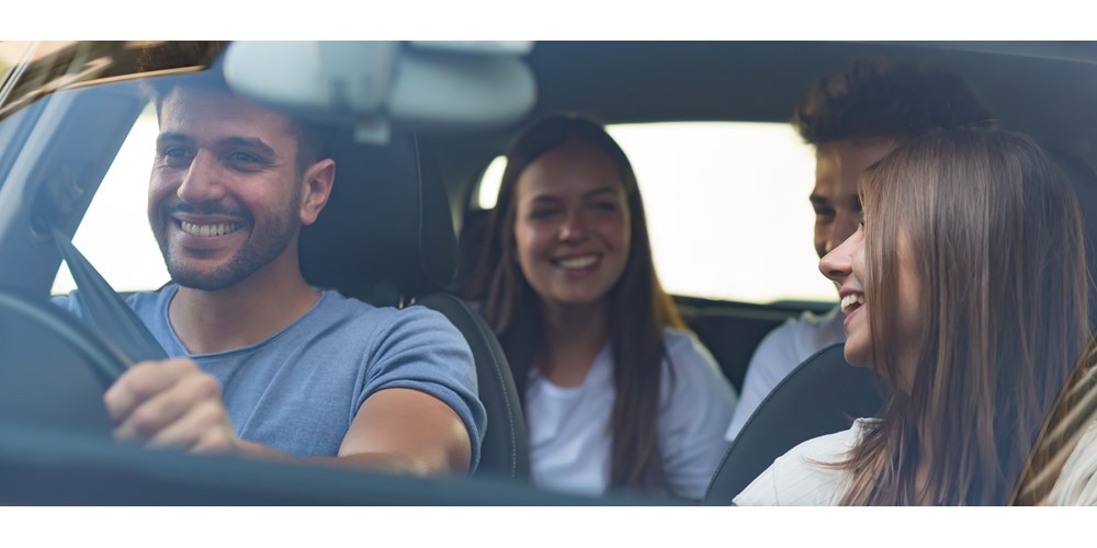 Car filled with friends laughing 