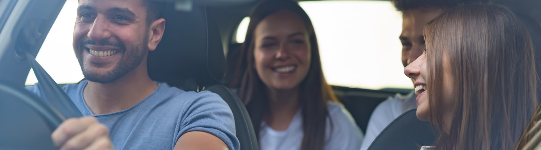 Car filled with friends laughing 