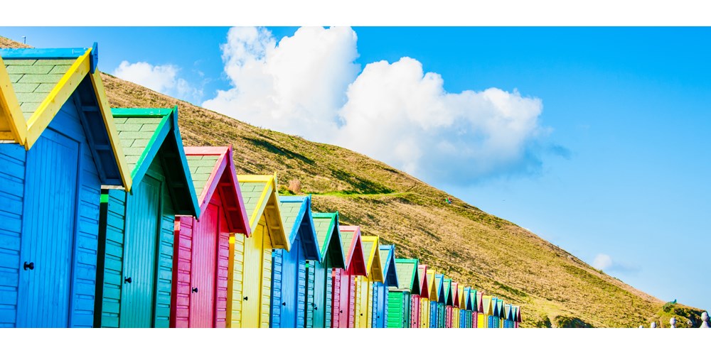 A row of multicoloured beach huts