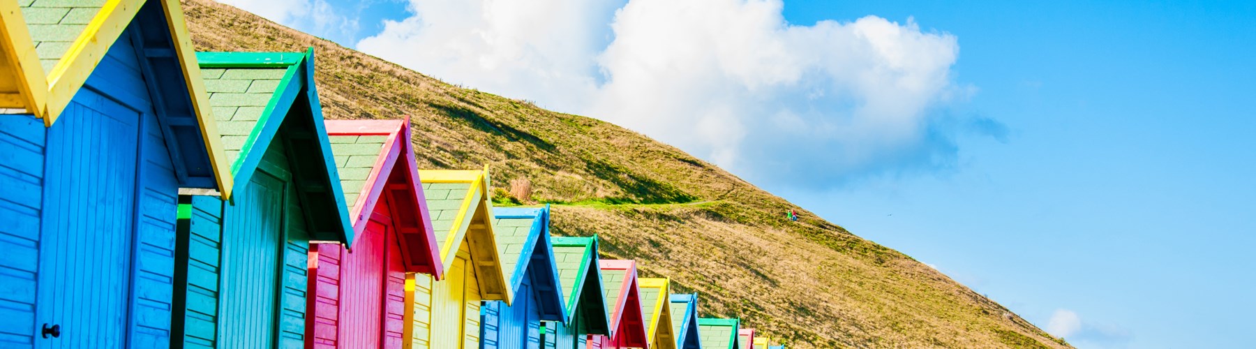A row of multicoloured beach huts