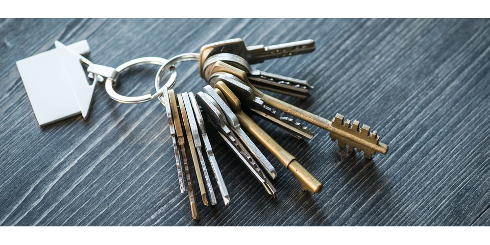 Someone unlocking a door with a key