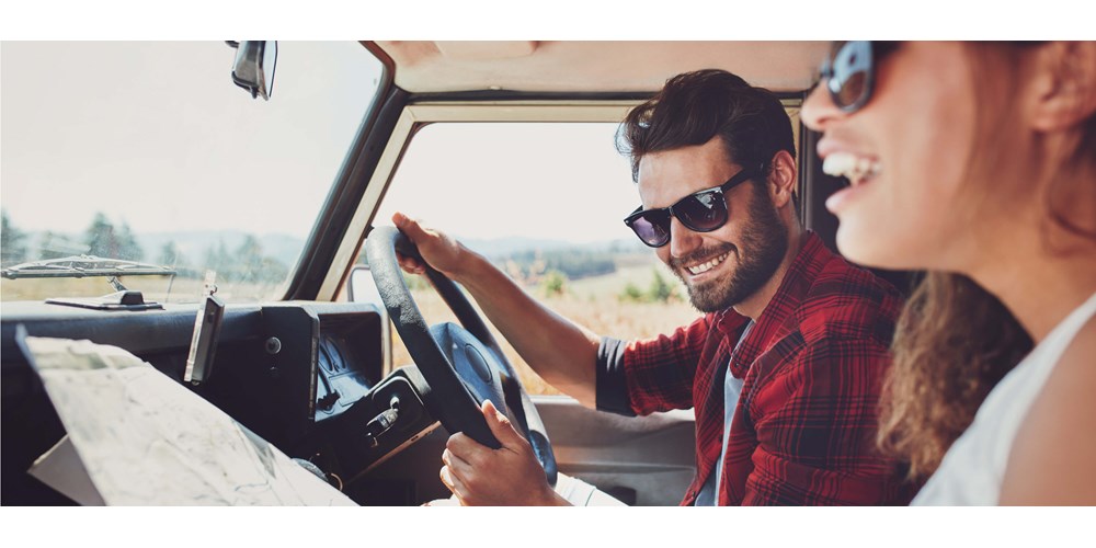 A couple looking at a map in the car