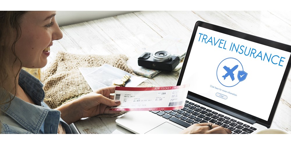 Young woman buying travel insurance online