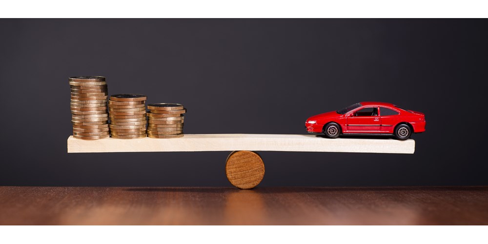 Toy car and coins on a scale
