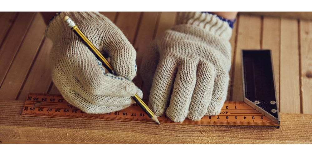 Carpenter using a ruler and pencil 