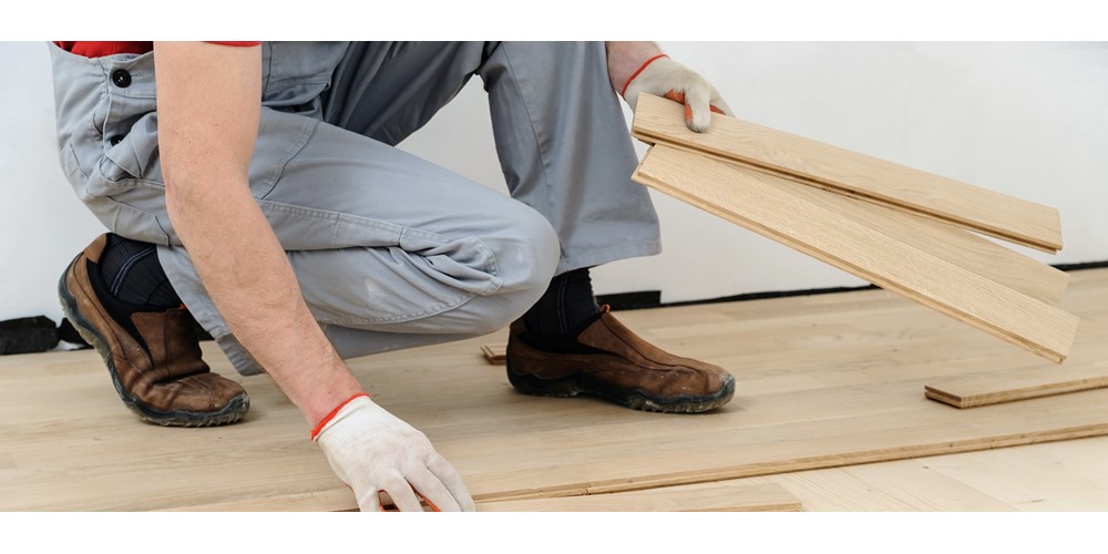 Man fixing floorboards