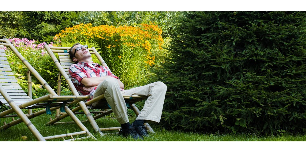 Man lounging in garden deckchair