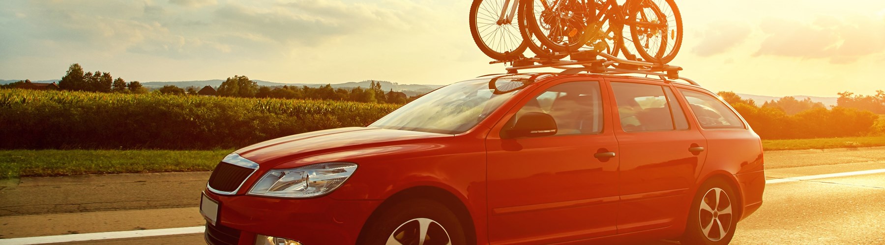 Red car carrying bicycles