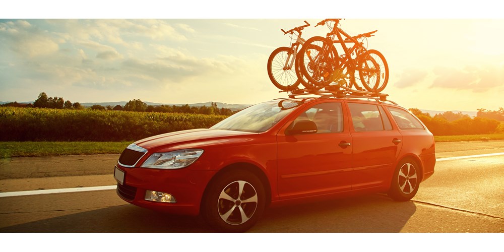 Red car carrying bicycles