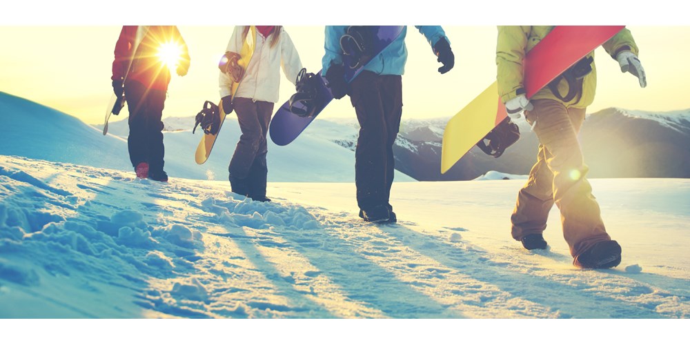 Snowboarders walking in the snow