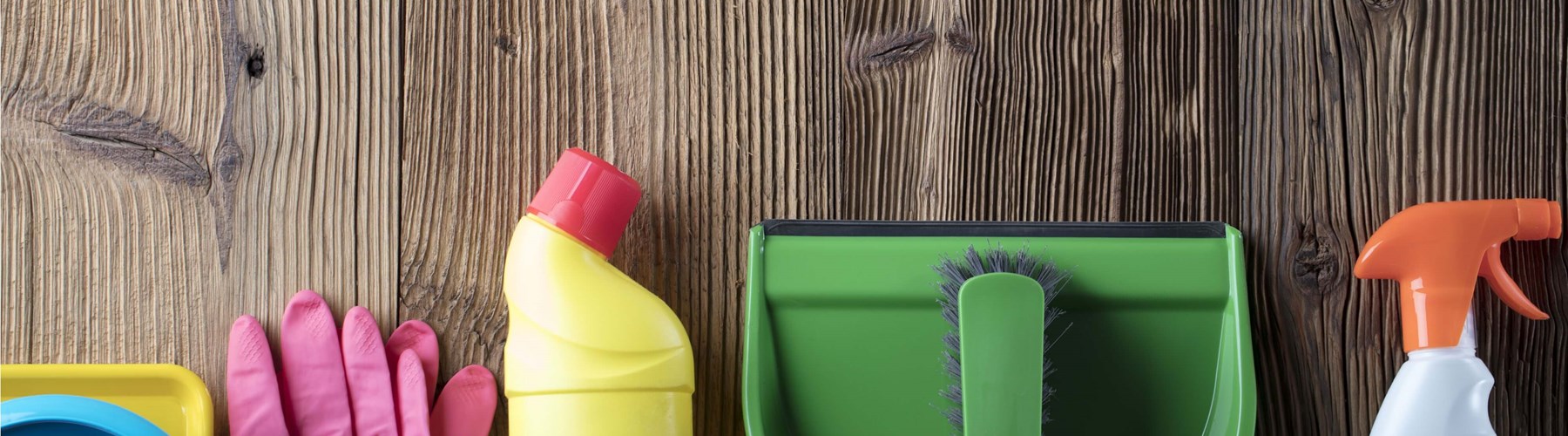 Household cleaning items on wooden flooring 