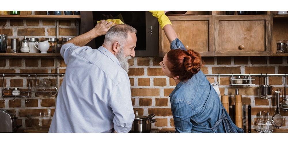 Couple cleaning kitchen