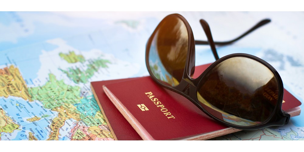 Sunglasses and passport on map