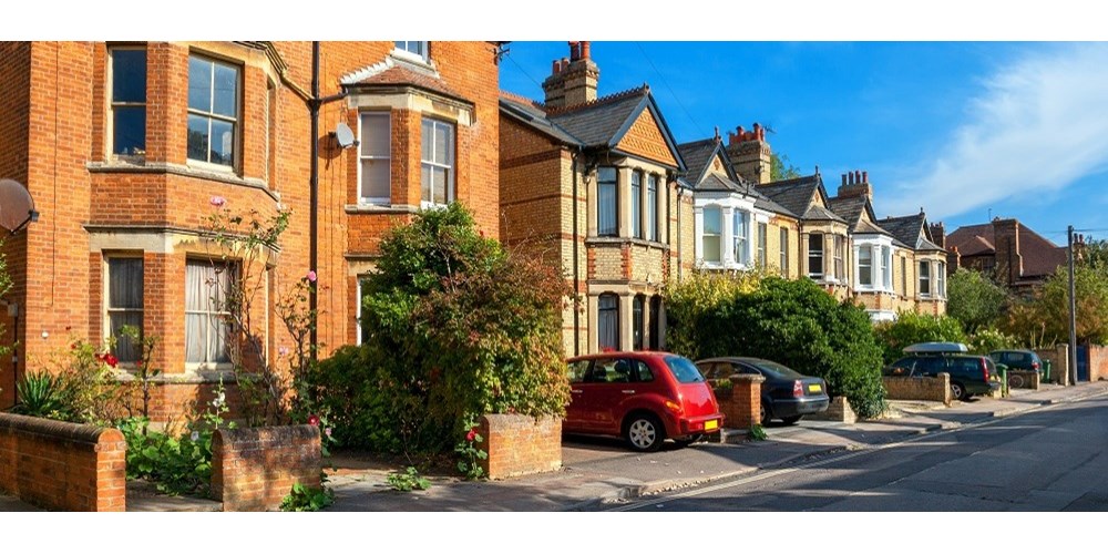 British houses with parked cars in driveway