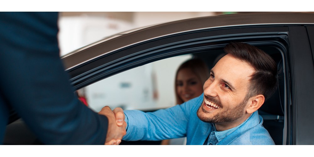 man shaking on buying a used car 