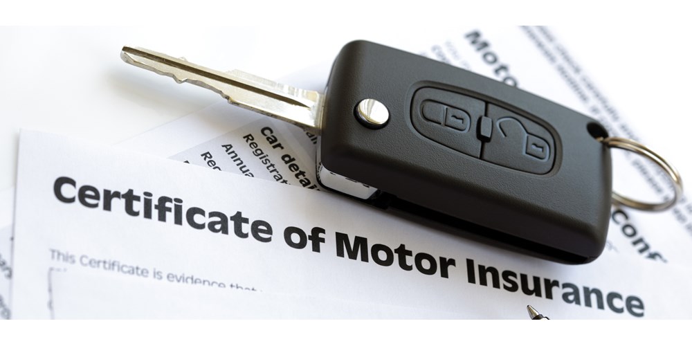 Car key on certificate of motor insurance