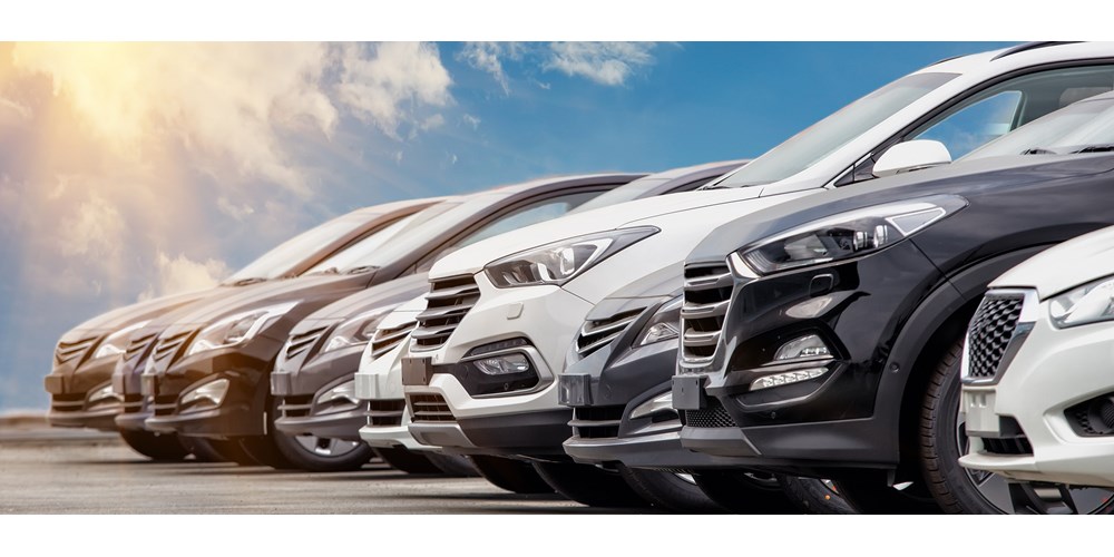 Black, white and silver cars in a row