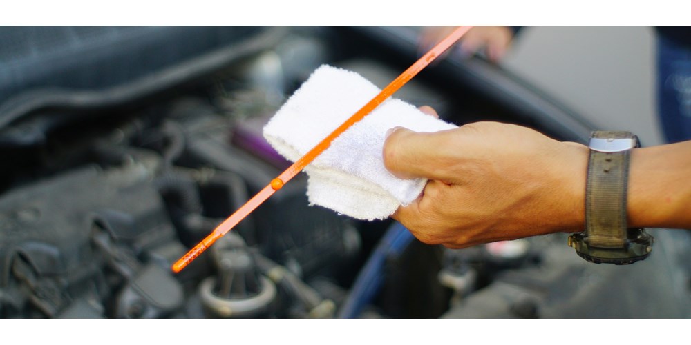 Man's hand checking car oil level