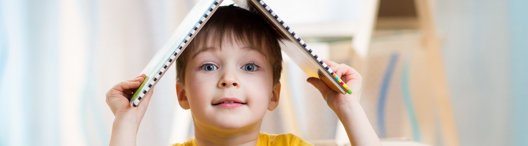 Child playing in box at home