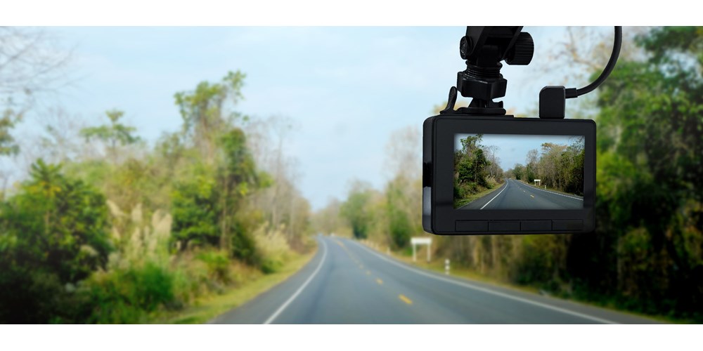 Car with dash cam on countryside road
