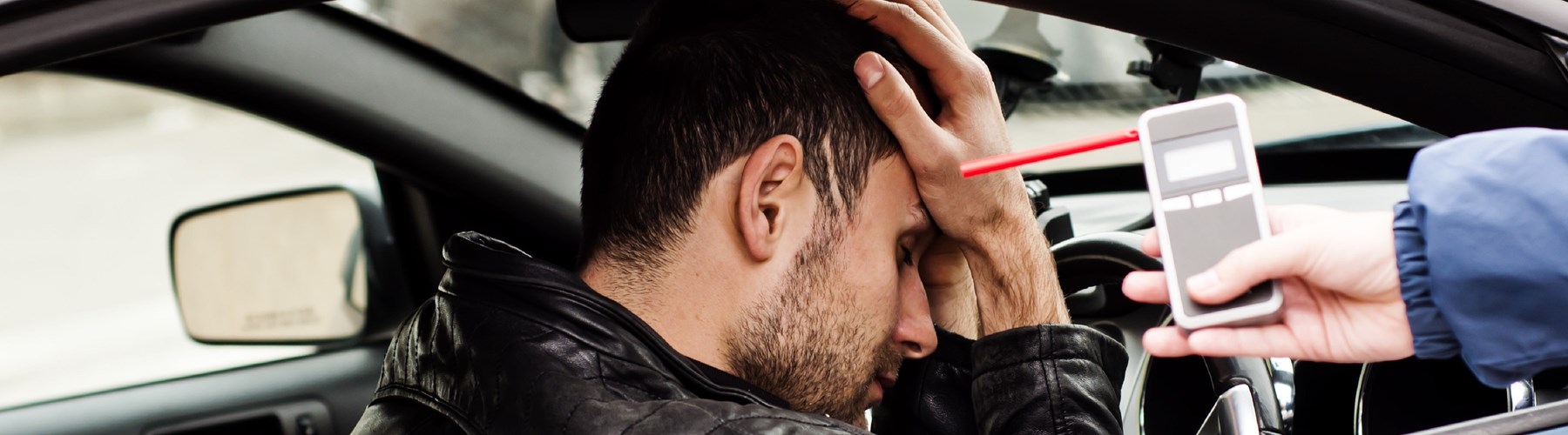 Man in car after being caught drink driving