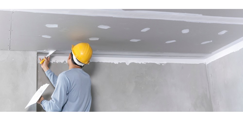 Builder plastering a wall