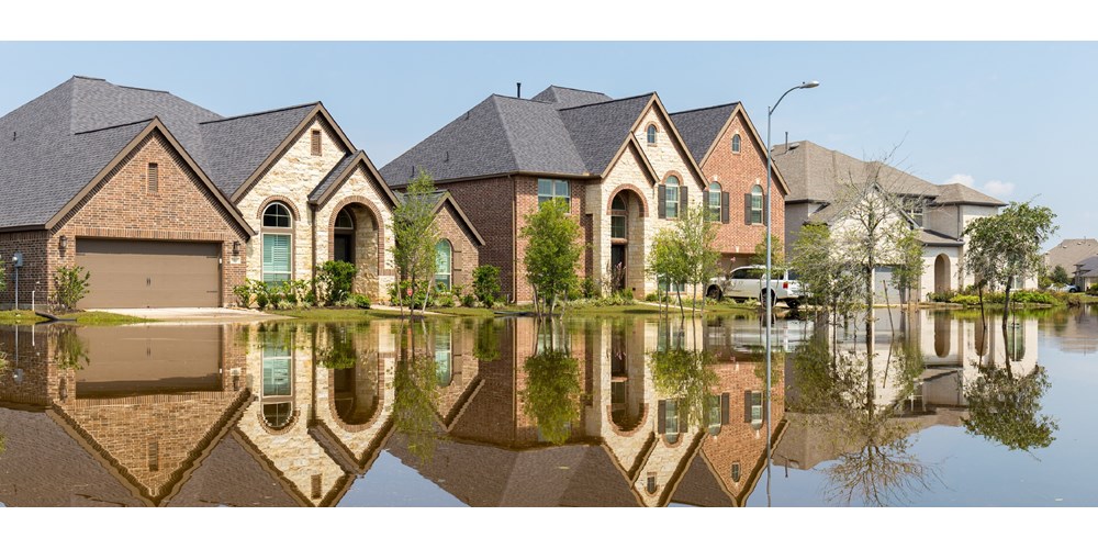 Three flooded houses with reflections in water 