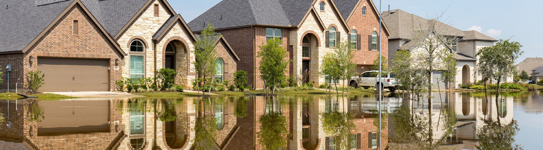 Three flooded houses with reflections in water 