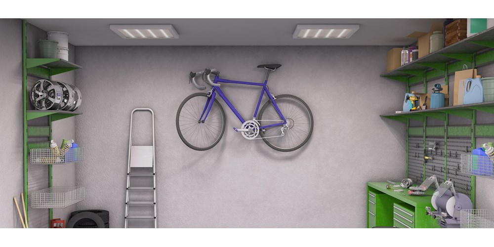 Purple bicycle hanging on the wall in garage
