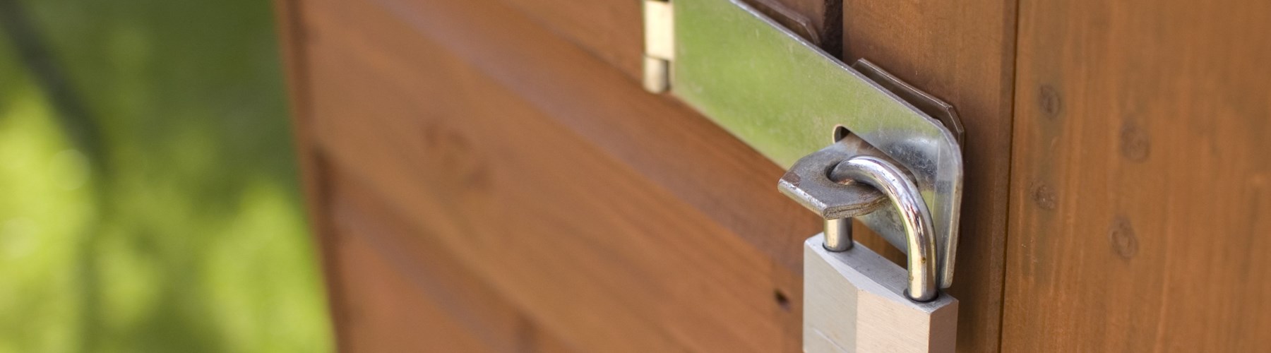 Garden shed with silver padlock on door 