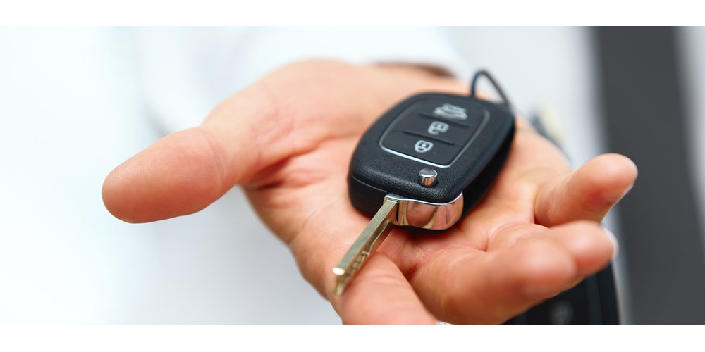 Hand holding an electric car key