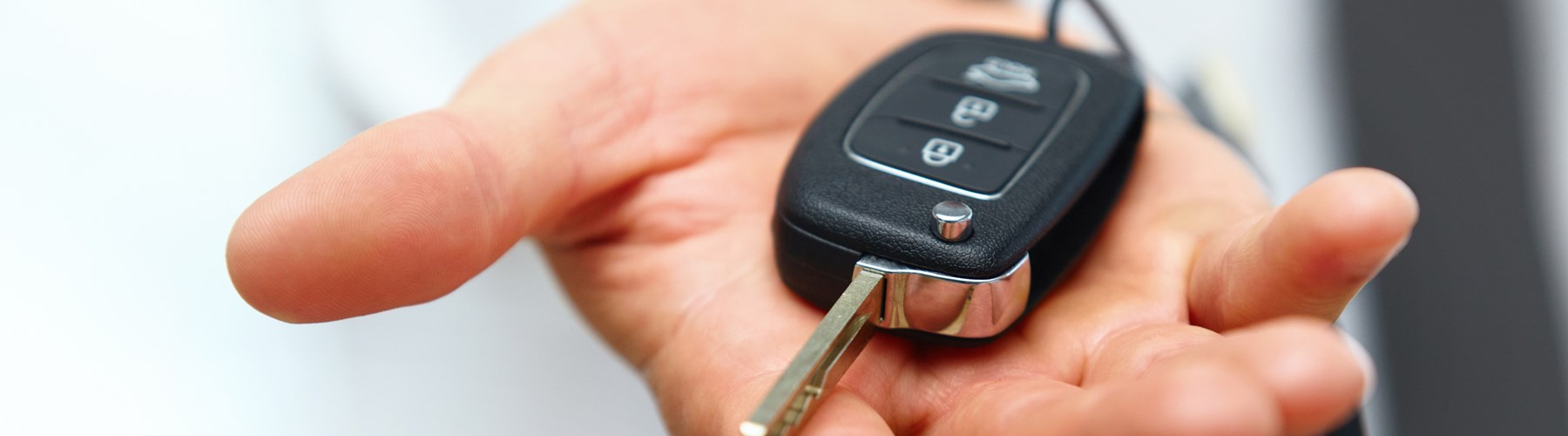 Hand holding an electric car key