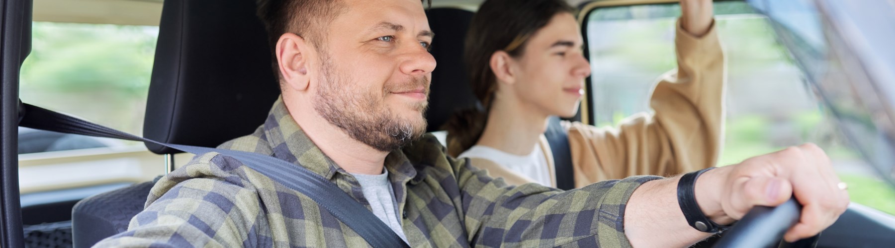 Father and son driving in car