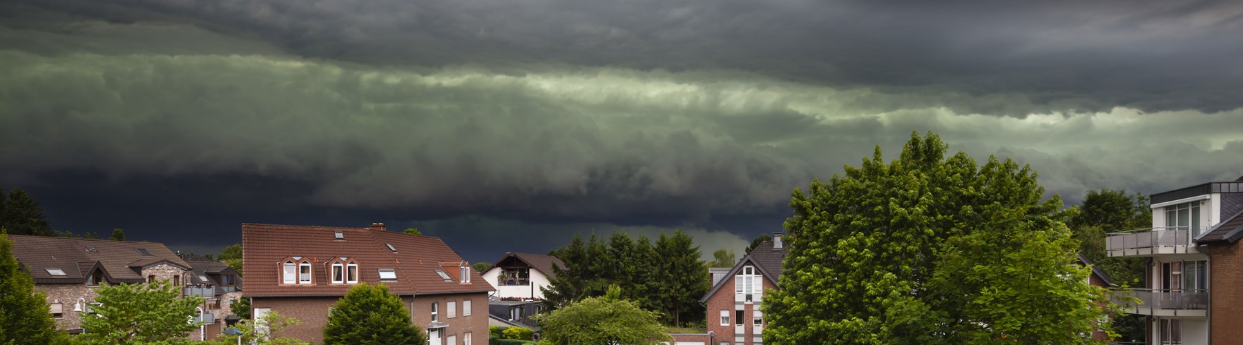 Home under stormy sky