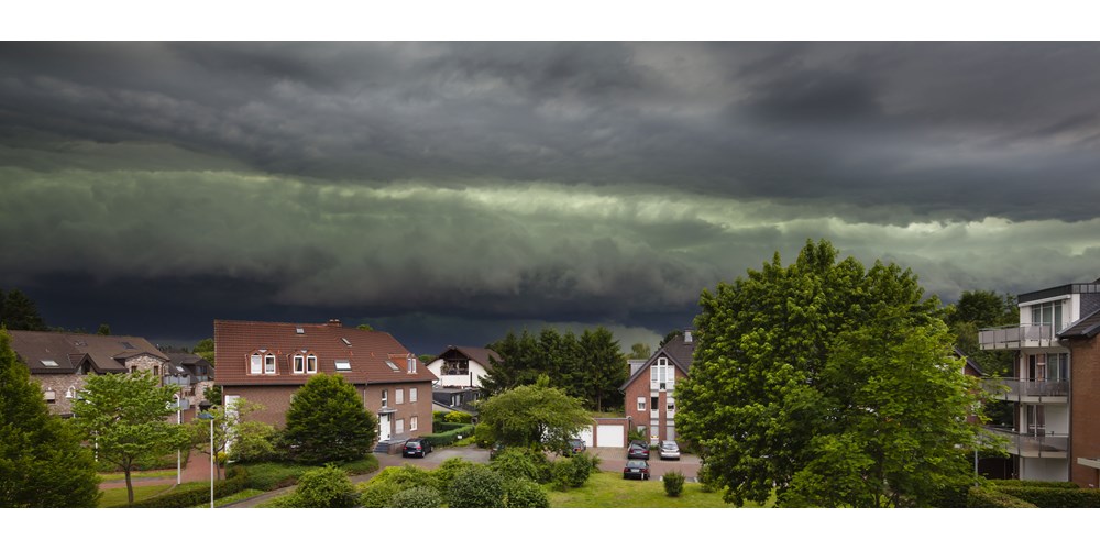 Home under stormy sky