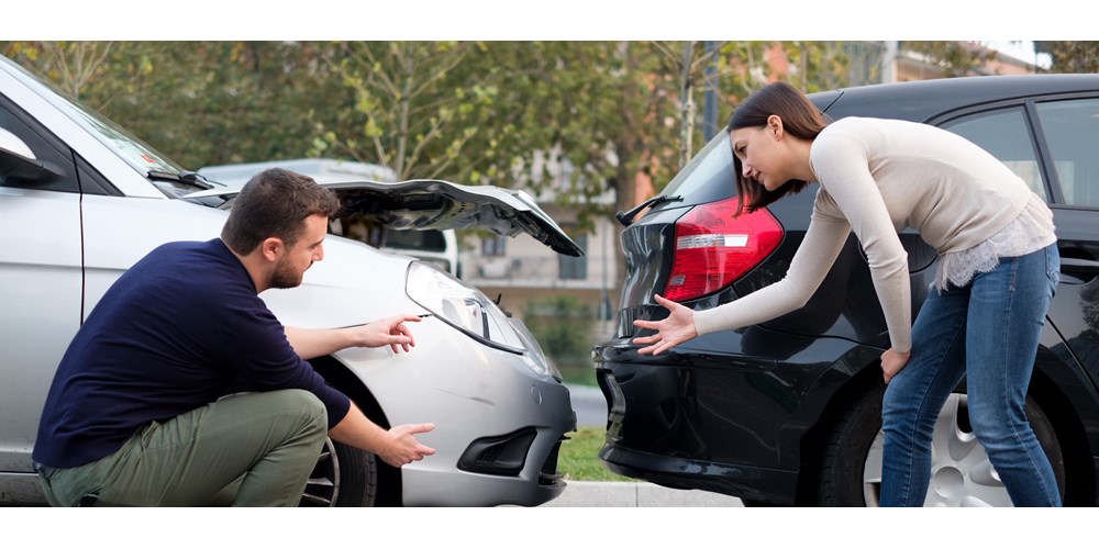 Man and woman arguing after car collision